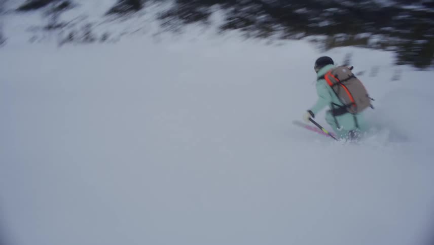 Person skiing down a snowy mountain