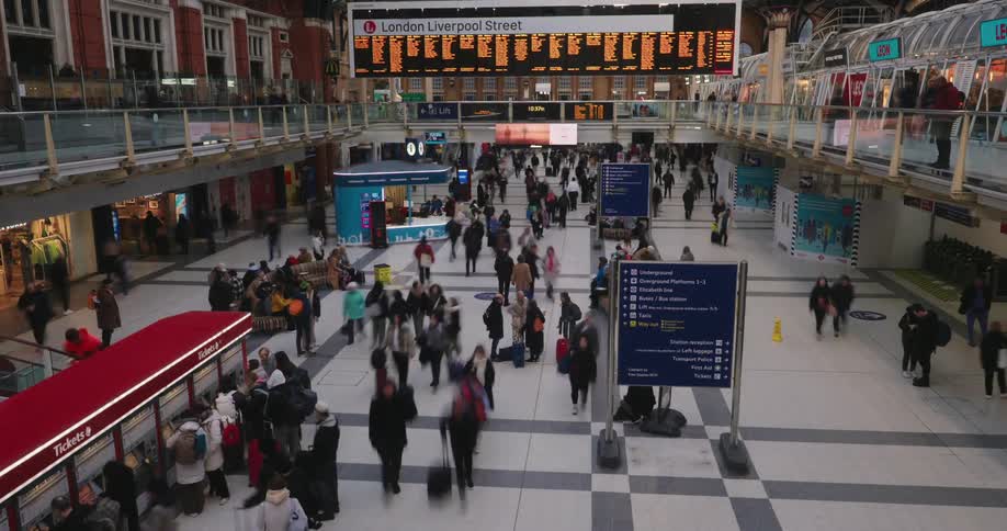 Crowd of people walking through a station