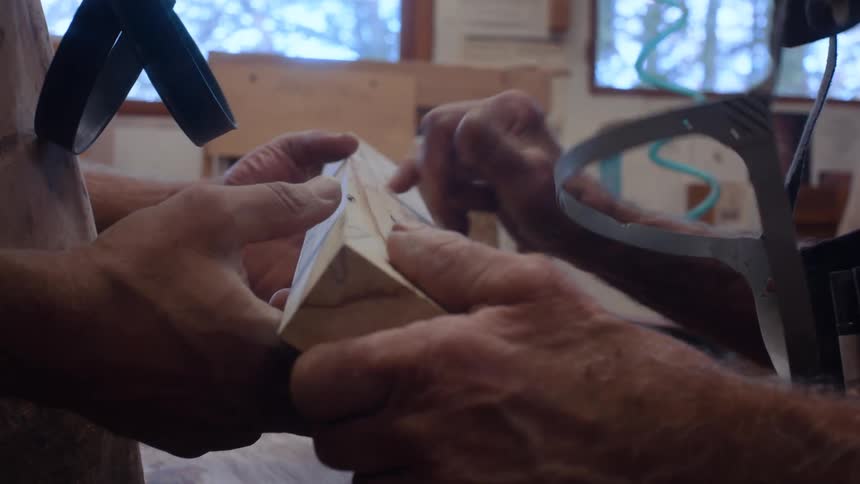 A clip of carpenters holding a wood