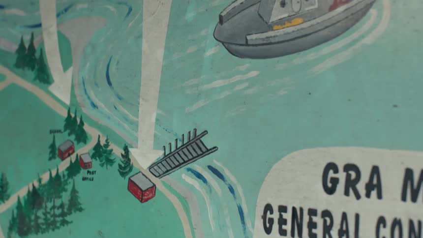 A mural on a wall shows a painted map with arrows pointing at the beach general store