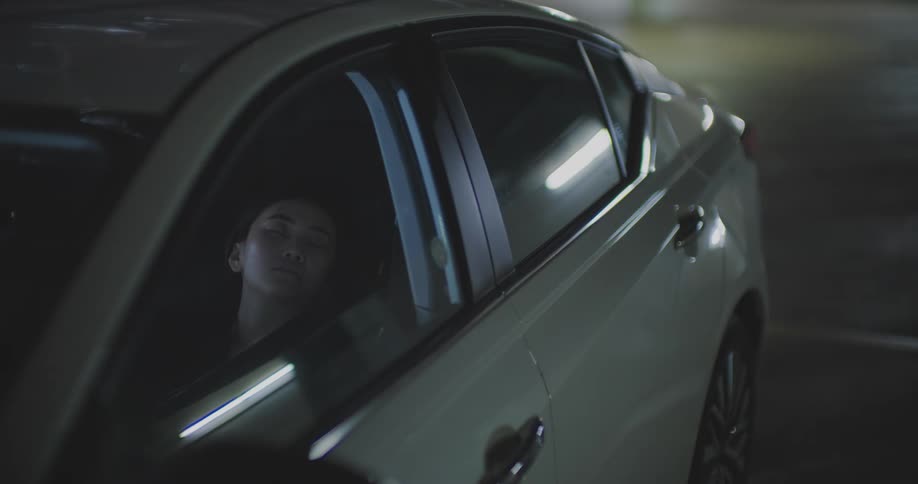 Woman sleeping inside the car