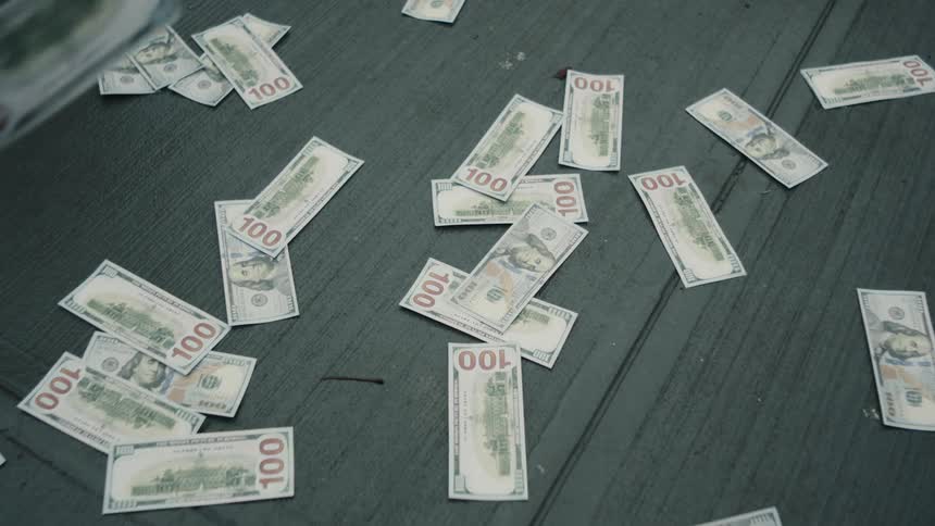 Dollar bills falling to the ground