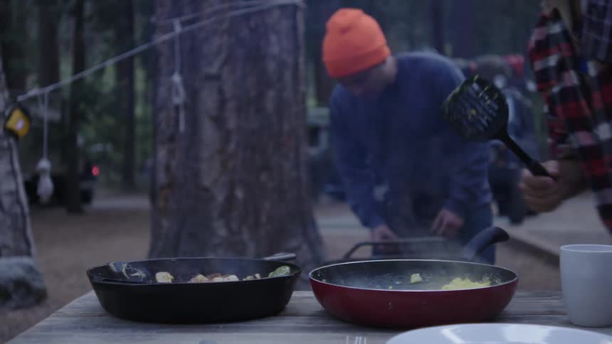 Food steaming in a pan outside on a picnic table