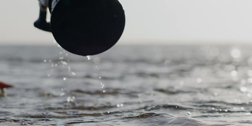 Professional camera being pulled out of the water