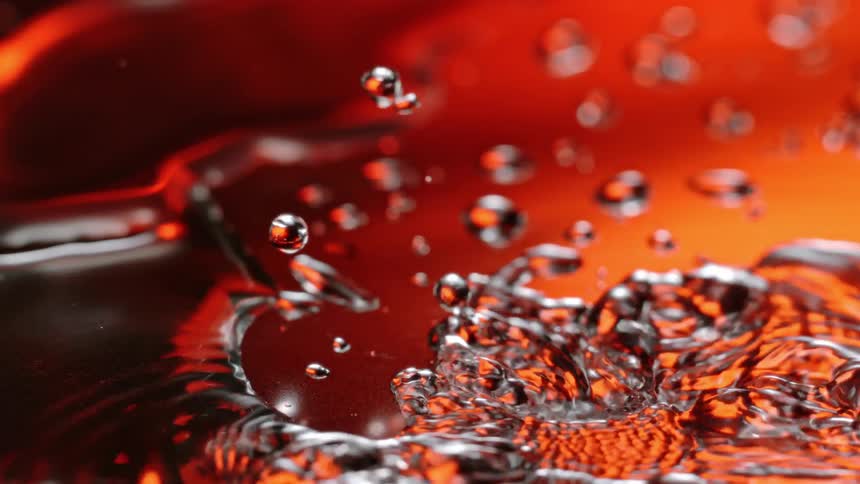 Water drops and splashes on the reflective surface
