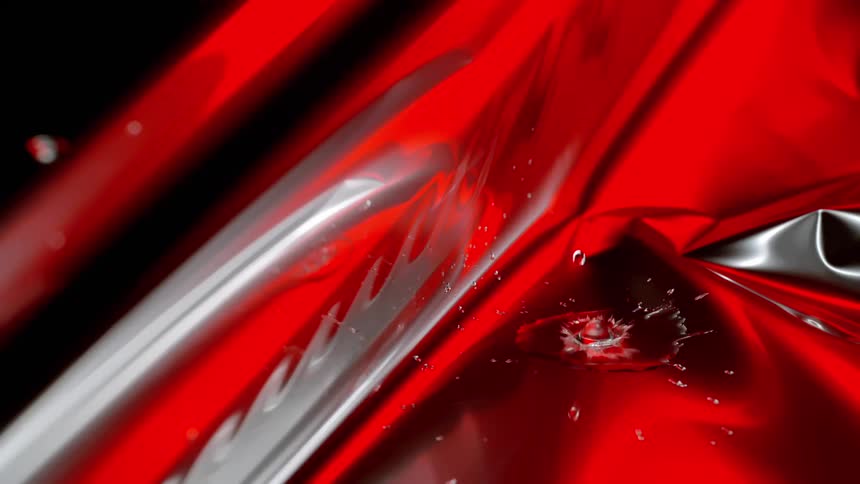 A footage of liquid dropping on a red surface