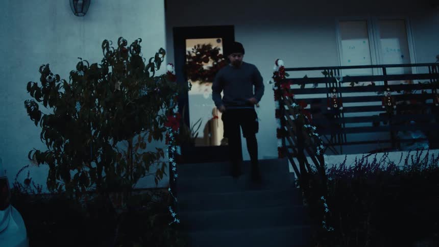Man exits his house and sets off on a jog