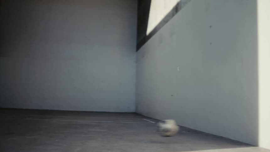 Man throwing ball against wall in goalkeeper mode
