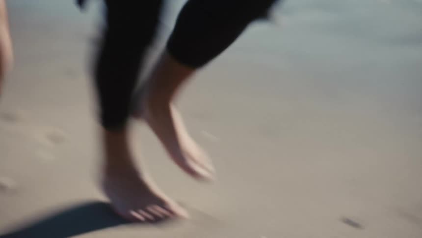 Couple jogging on the beach near the shoreline