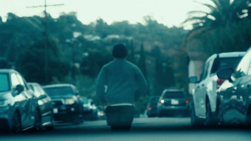 View from a car windshield of a person running on the street