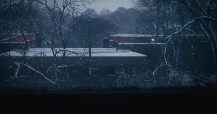 Snow falls on an Atlanta apartment building in winter