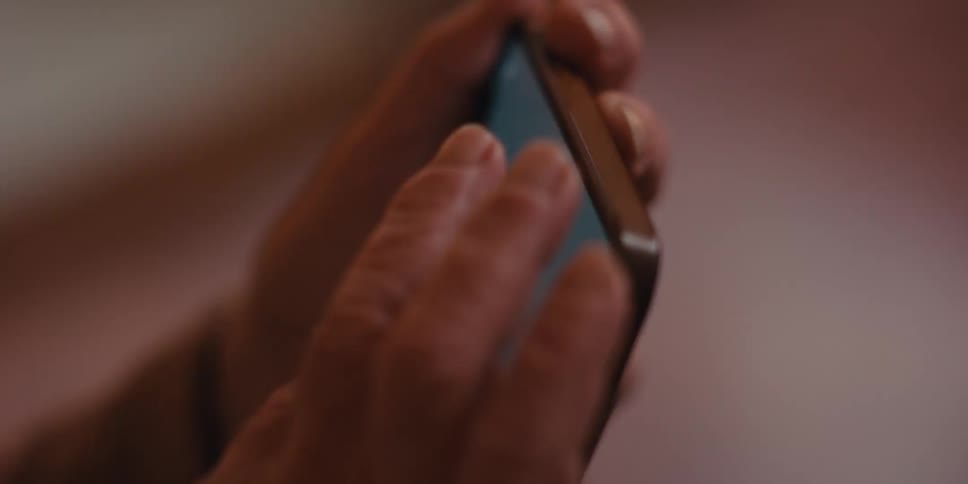 Close up of a pair of hands holding an iphone