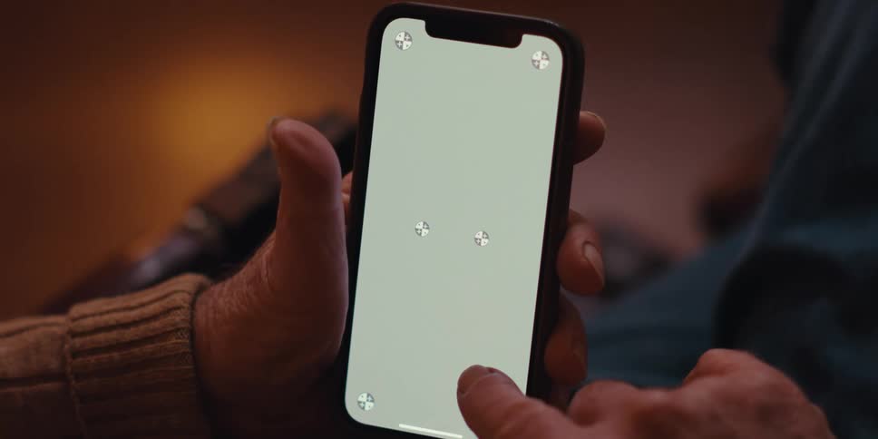 Elderly hand scrolling finger on an iphone screen