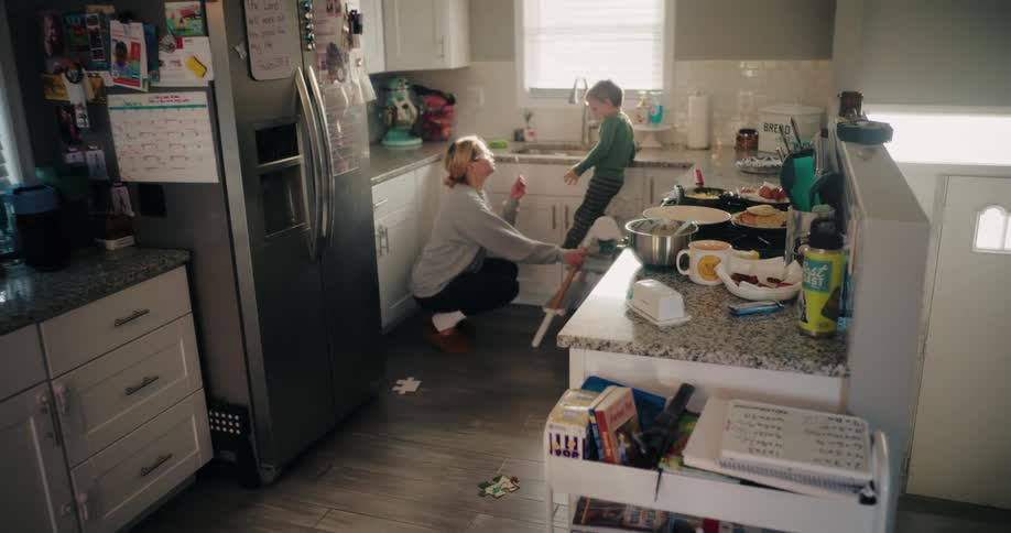 Mother in the kitchen with three small children