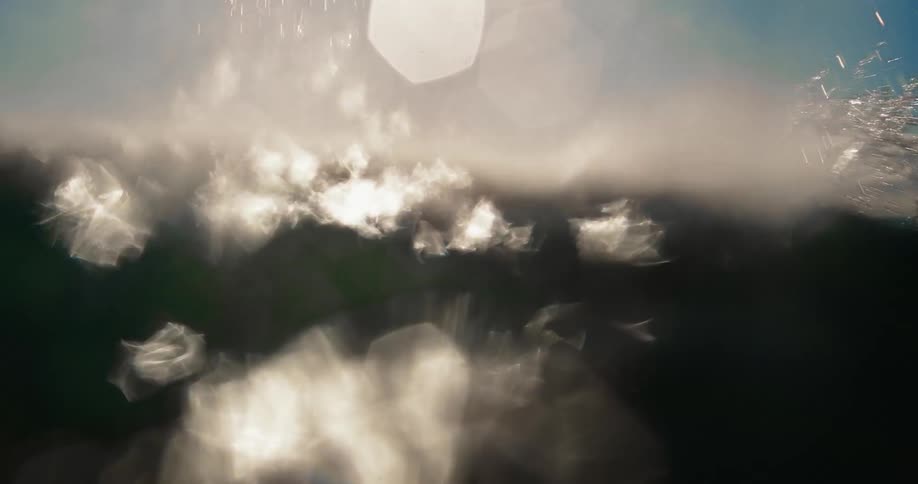 A person underwater in the ocean struggles to stay afloat
