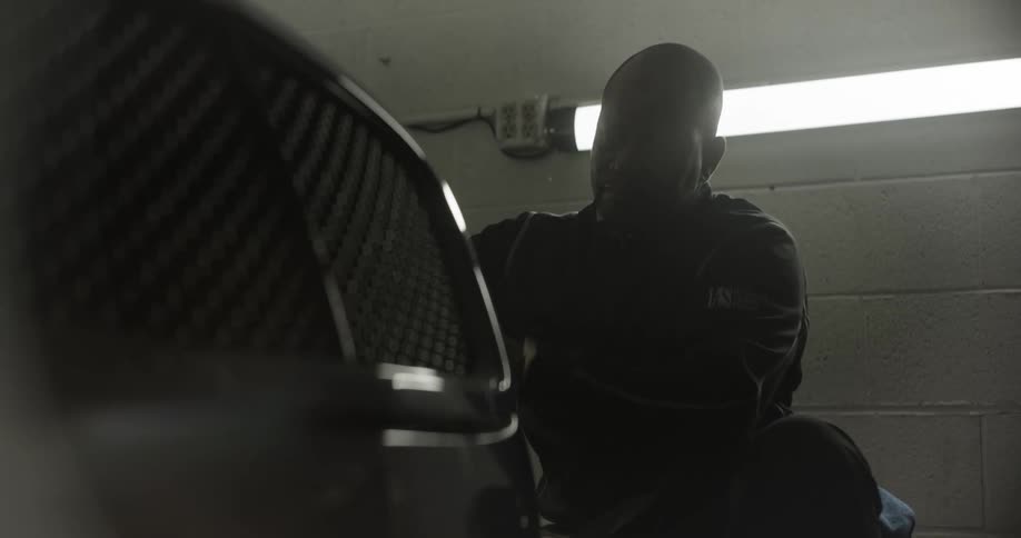 Man polishing the front of a vehicle