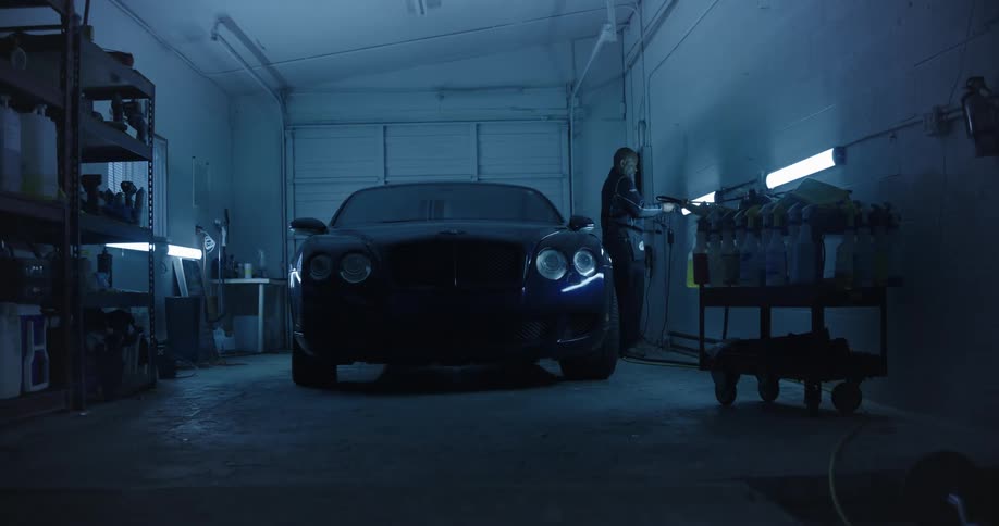 Man turning on the interior light of a garage