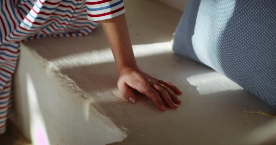 A person is sitting by a pillow