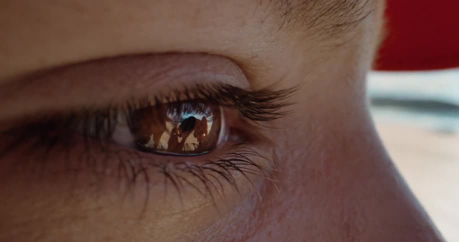 A person looks through a pair of binoculars