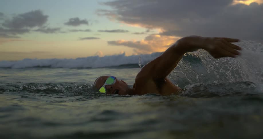 Person with glasses swimming in the sea