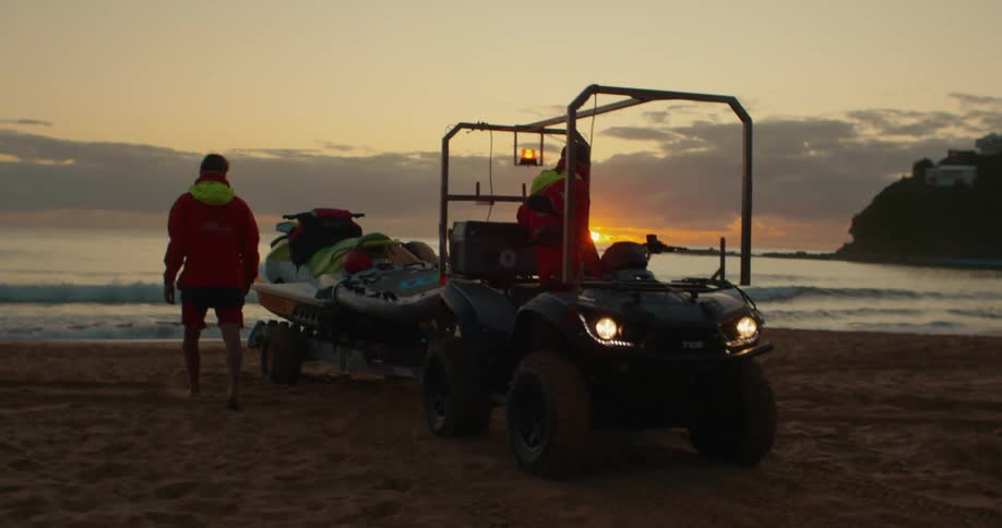 A jet ski is being delivered on the beach