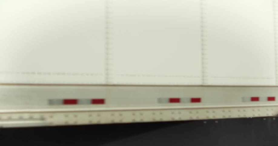 A blue freight truck drives in front of large white cranes and stacked shipping containers at a port