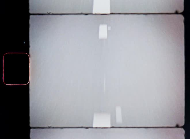 Moving view of a paved road with white stripes