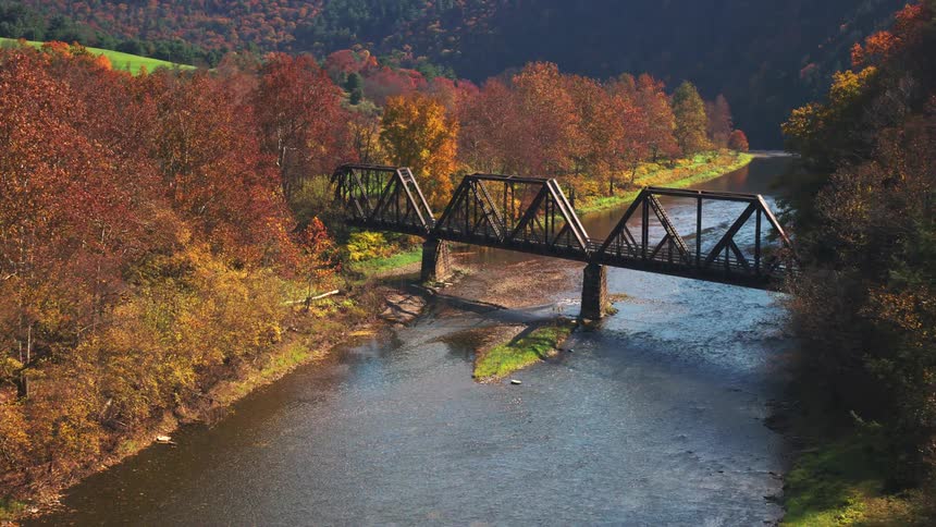 A bicycle rides across the bridge on the stream