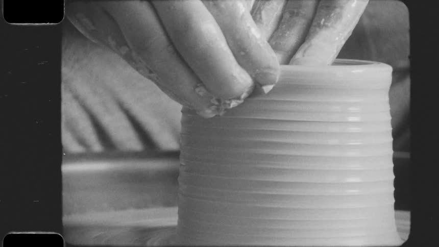 A persons hand molding clay using their fingers