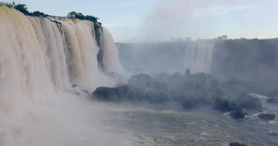 Iguazu falls powerfully cascades water into a canyon creating mist and flowing water