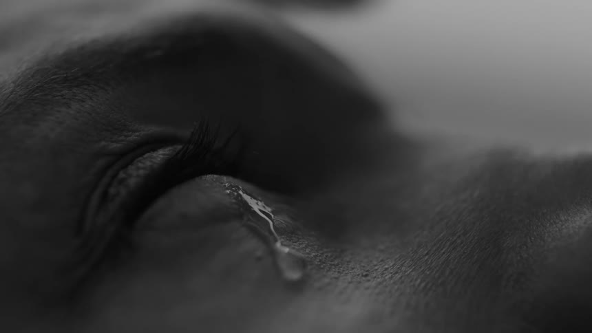The eye of a person who is trying hard to cry and a tear is coming out