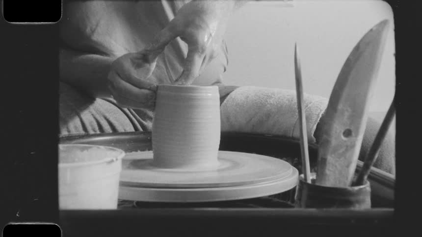 A man is sculpting on a pottery wheel