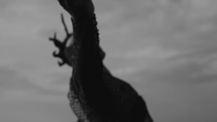 A man is dancing and waving his arms out to the sides and above his head in slow motion