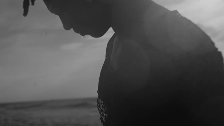 A man is dripping water on the beach