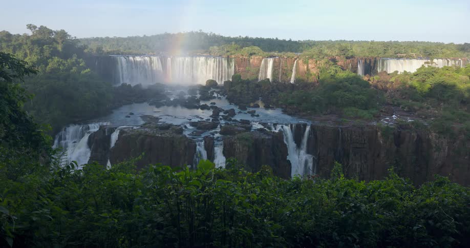 A rainbow is over the large waterfall