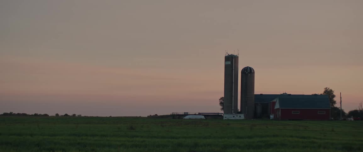 Tall grain silos seen on a farm