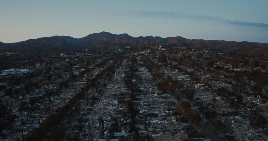 A big city in on the outskirts of a mountainous landscape