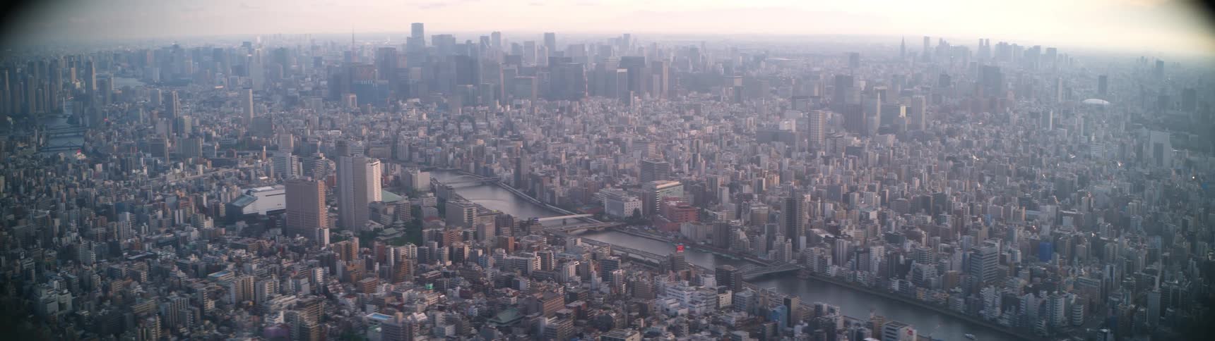 Expansive tokyo skyline viewed from tokyo skytree revealing a densely packed cityscape intersected by rivers