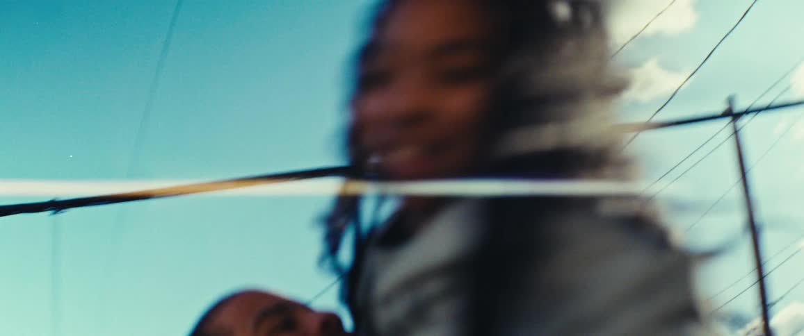 A father hugs and spins his daughter around