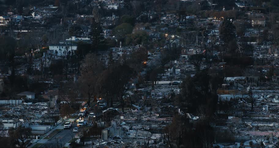 Emergency vehicles fill the roads in the destroyed town