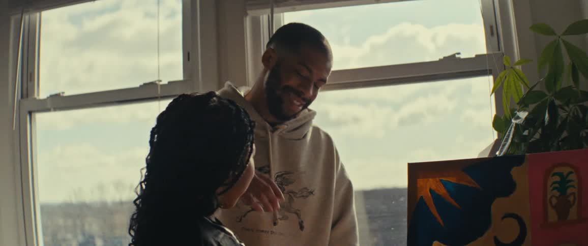 Father next to his daughter looking at a painted picture