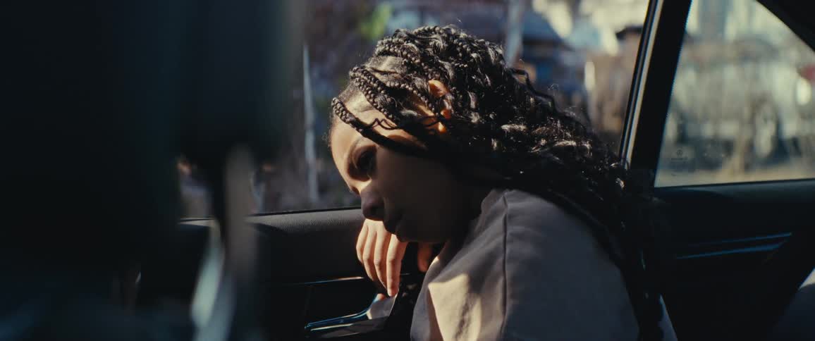 Sad girl sitting in the back seat of a car