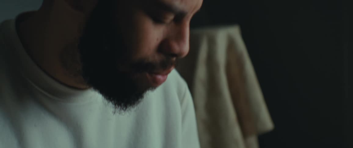 Bearded man sitting looking at a picture in a frame