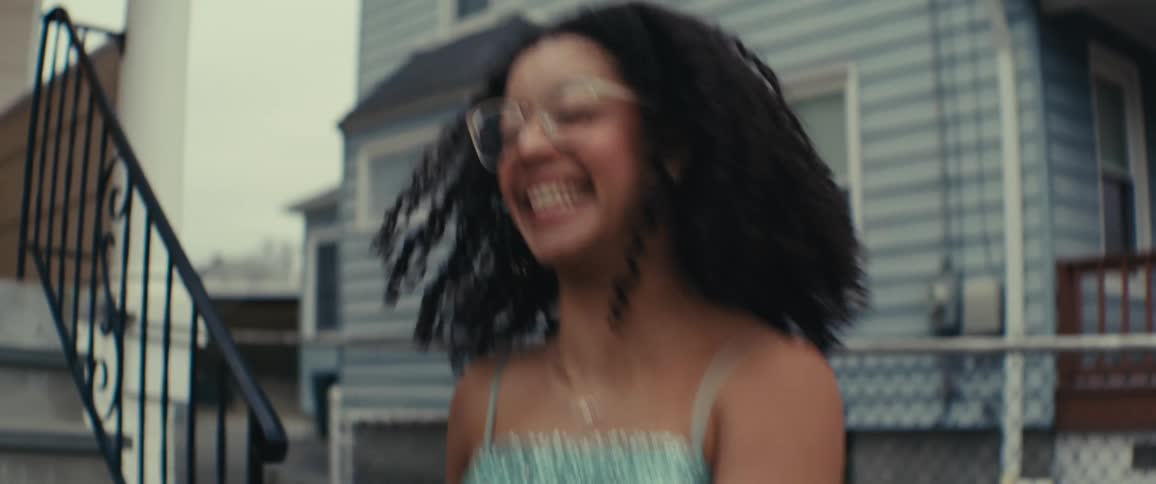 Friends dance in front of the home