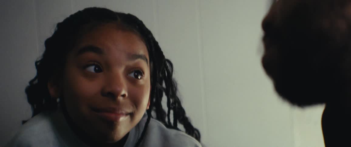 Girl smiles while talking to her father at home