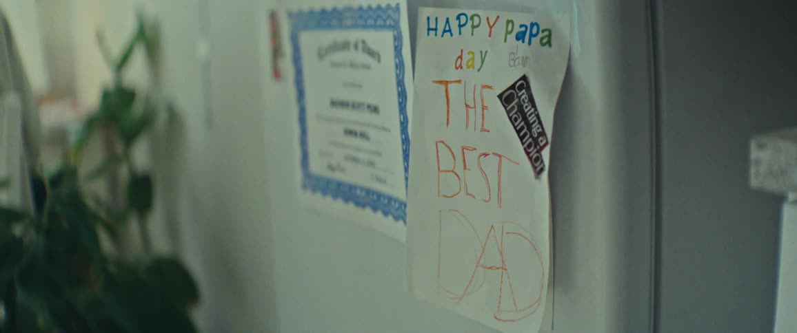Drawing with writing happy fathers day on the refrigerator door