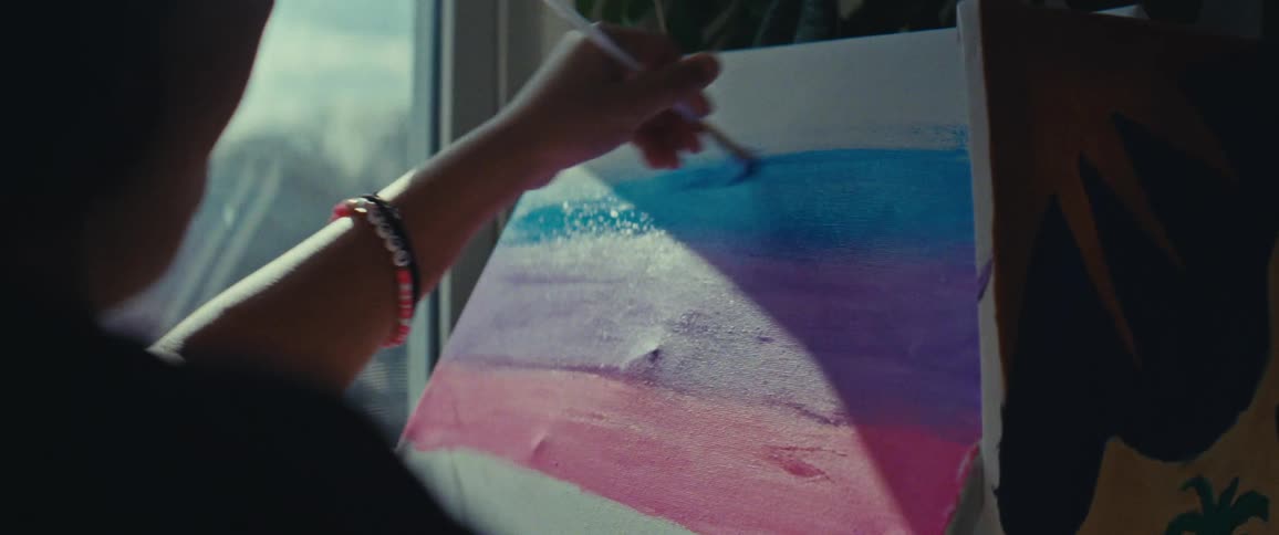 Hand with brush painting a picture