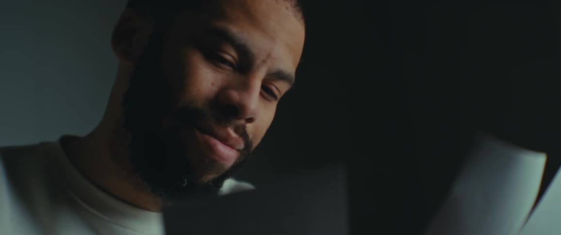 Portrait of a bearded man looking at photos