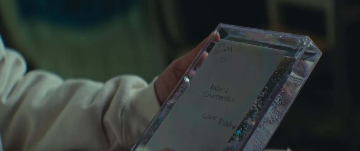 Person holding an acrylic frame with fluid inside