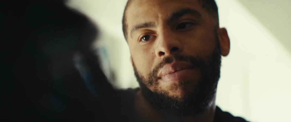 Closeup of a bearded mans face as he looks lovingly at another person